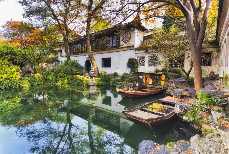 Autumn view of Suzhou's Humble Administrator's Garden with golden leaves and classical Chinese pavilions
