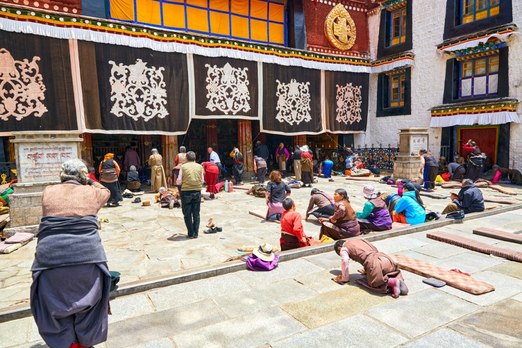 Devotee praying outside Jokhang Temple in Tibet