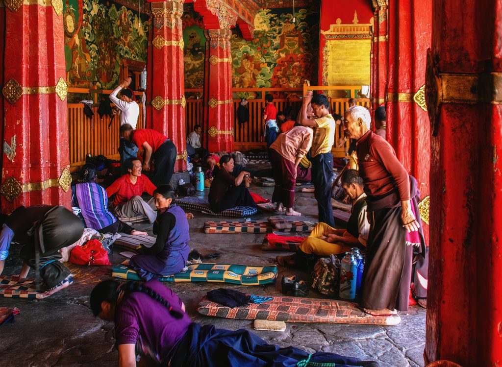 Devotee praying inside Jokhang Temple in Tibet