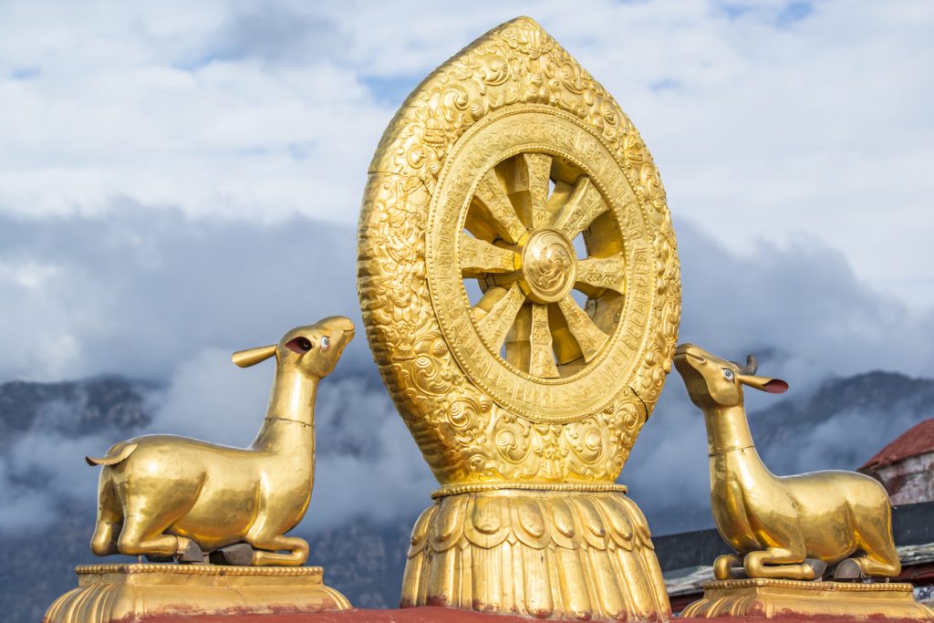 Golden roof of Jokhang Temple with deer and Dharma wheel in Tibet