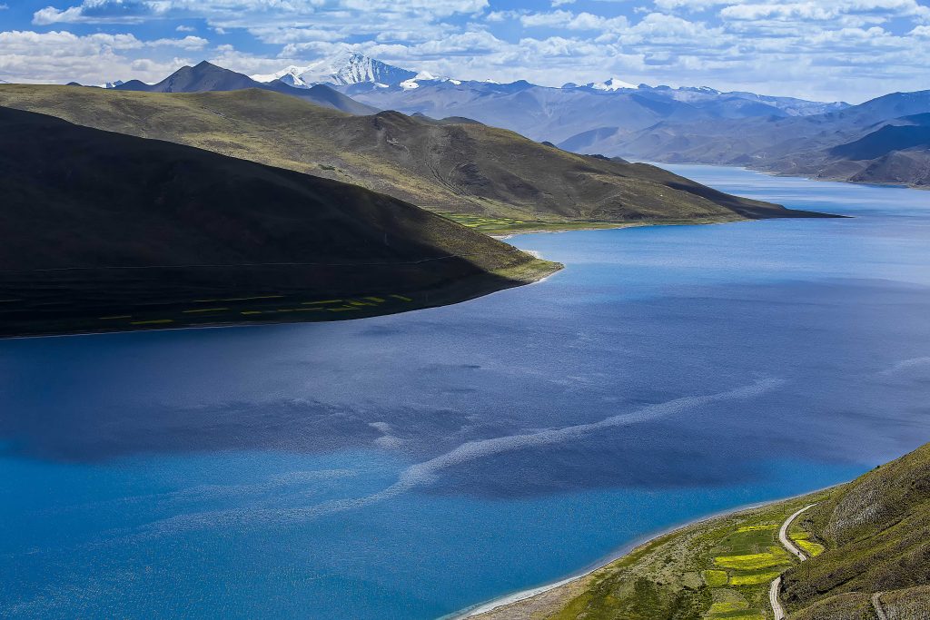 Clear blue water surface of Yamdrok Lake in Tibet